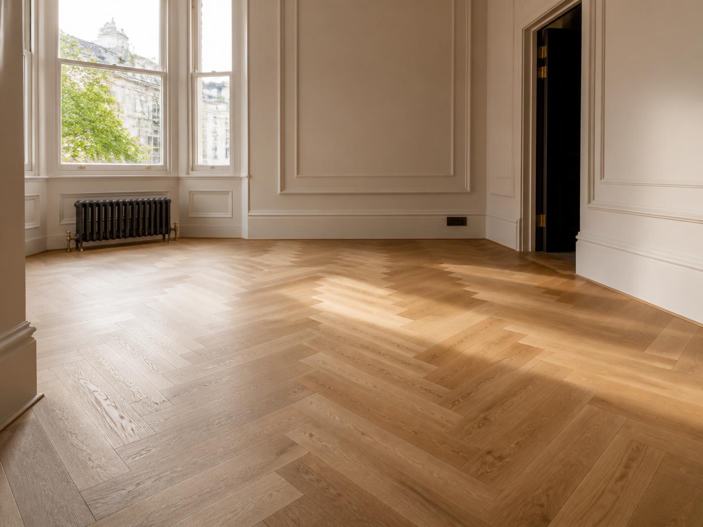 Newly laid engineered oak herringbone flooring in an empty period London room