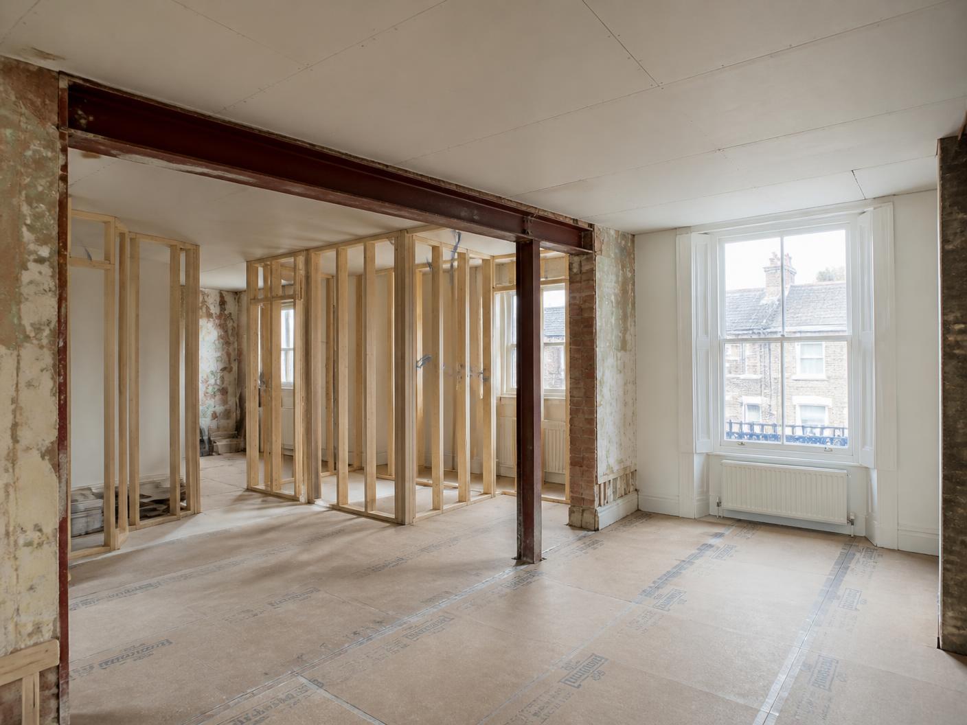 London property mid-works with new timber stud partitions and a steel beam opening
